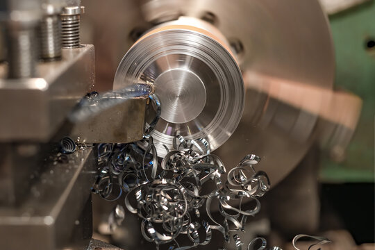 End trimming with a cutter on a lathe. Metal shavings on the machine.