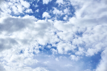 White porous clouds on blue sky on a sunny day, cloudy landscape.
