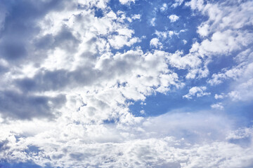 White porous clouds on blue sky on a sunny day, cloudy landscape.