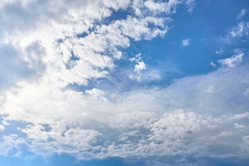 White porous clouds on blue sky on a sunny day, cloudy landscape.