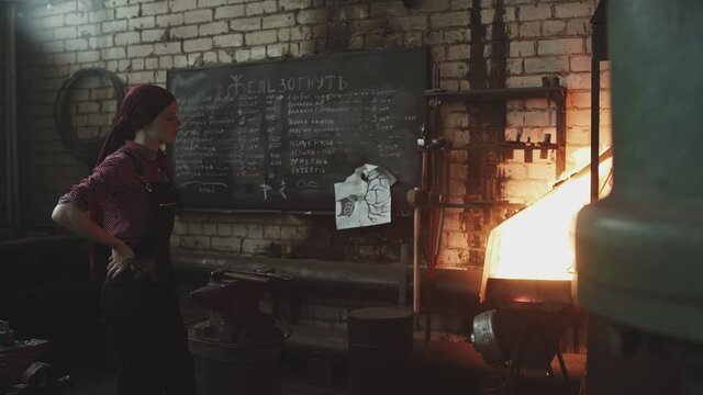 blacksmith girl working in her workshop