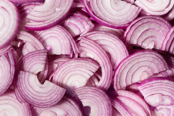 Sliced purple onions. Spanish red onion slices. Horizontal slicing. Background.