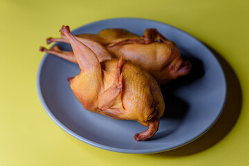 Smoked quail meat on a plate. A photo.