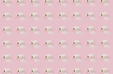 Obraz premium Rolls of white toilet paper on pink background.