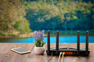 Wireless internet router with connected cables, The backside of fiber optic internet, and network...