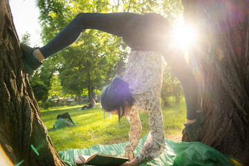 Young flexible woman read book on picnic. Possibility, passion and goal concept