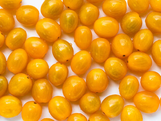 High angle view of full frame image of bright yellow tomatoes. Suitable for food background or artwork.