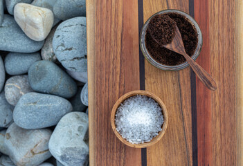 Preparing homemade coffee scrub with himalayan  salt on a wooden board on a background of sea...