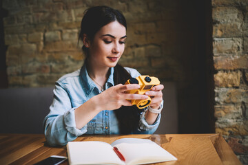 Calm woman photographer watching photos on camera