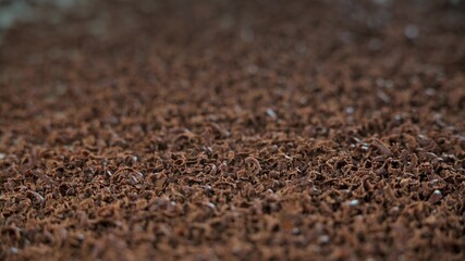 Sweet grated chocolate for cooking dessert. Background in blur.