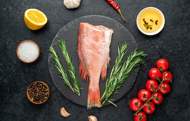 Raw red sea bass fish on stone background