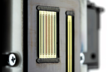 Macro shot of the printing nozzles in the inkjet printer head, seven nozzles visible.