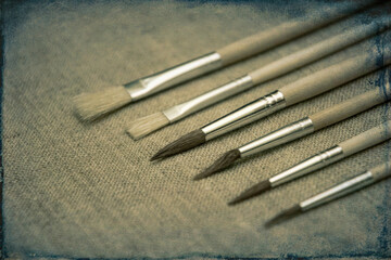 Fototapeta premium Brushes for drawing on a background of a canvas