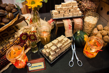 Fall festive food spread with fudge flowers and colorful leaf decor. Top view