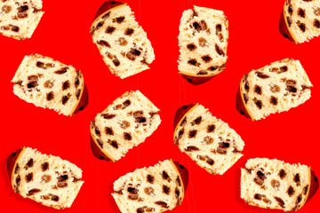 Pieces of chocolate panettone. Chocottone Falling in motion on red background.