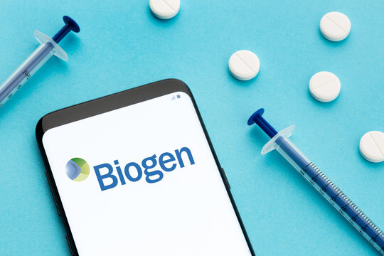 Galicia, Spain; June 8, 2020 : Smart phone showing Biogen logo on screen and pills and syringe on blue background