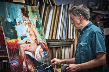 Senior artist painting in art studio