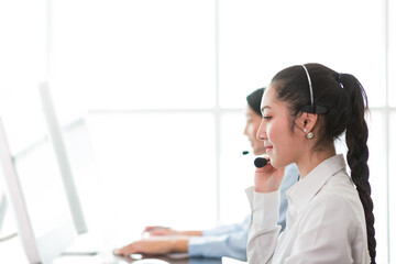 Group of call center woman worker at work. Female customer support operator with headset working in...