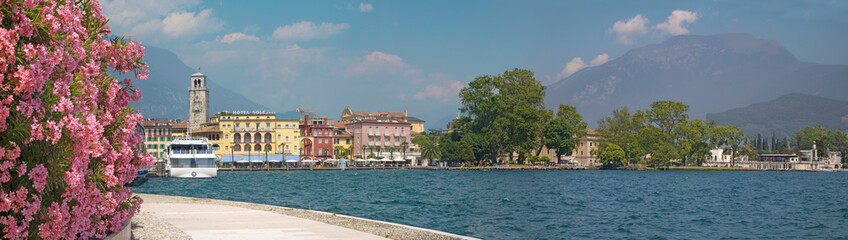 Fototapeta na wymiar RIVA DEL GARDA, ITALY - JUNE 6, 2019: The City from south with the Alps in the backgound.