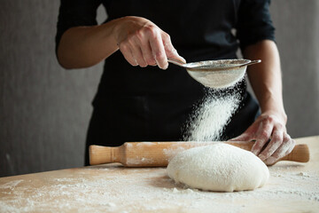 Photo of flour and men hands with flour splash. Cooking bread. Kneading the Dough.