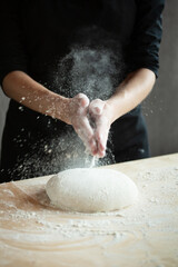 Photo of flour and men hands with flour splash. Cooking bread. Kneading the Dough