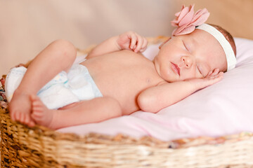 Sleeping European newborn girl in diaper