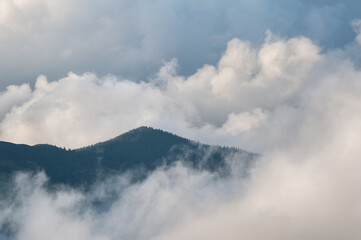 Low clouds and mountains silhouettes. Picturecque mountain landscape after the rain