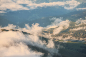 Low clouds and mountains silhouettes. Picturecque mountain landscape after the rain