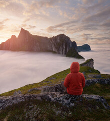 A tourist enjoying a view at the Mountain Hesten, Senja, Norway. Trekking in Norway, active life concept
