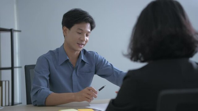 Business concept of 4k Resolution. Asian man presents marketing plan in office.