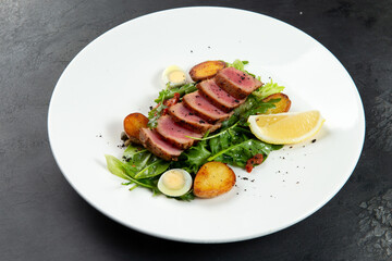 fried tuna on a pad of green beans