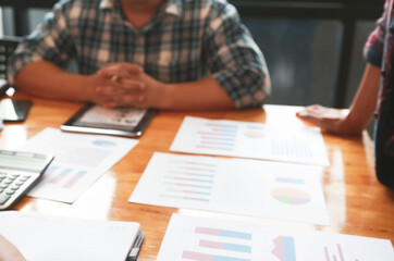 Team Businessmen are meeting for calculating and analyzing performance statistics for future investments.coordinate concept.