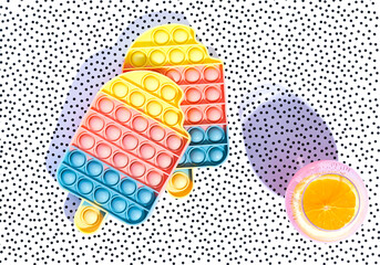 Two antistress ice creams on a stylish background in a dot. Trend 2021. Summer Concept