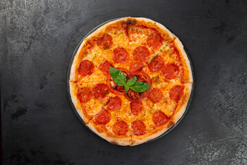 pepperoni pizza on a dark background. close-up.