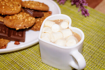 Obraz na płótnie Canvas peanuts and chocolate close-up cookies. A cup of coffee with marshmallows.