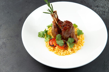 Lamb shank on a pillow of risotto, in a plate