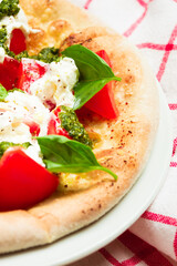 Fresh pizza made from yeast dough from wood-fired oven with mozzarella and basil
