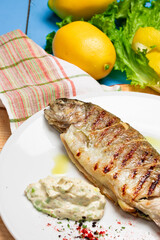 Grilled seabass with lemon and fresh vegetables. Rustic Served Dish