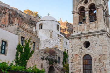 Fototapeta na wymiar Low Angle View of a Medieval Byzantine Church and Stone Βelfry Tower in Monemvasia Island, Peloponnese, Greece. Historic Buildings inside Castle Town Heritage of Byzantine Empire.