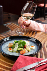 Fried scallops with herbs and red caviar.