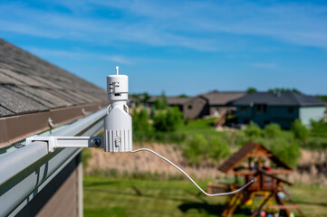 Wireless sprinkler rain sensor used to conserve water. Device is installed on a residential roof...
