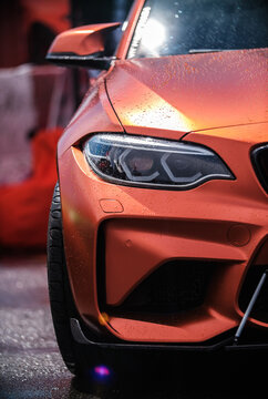 BMW M3 F80 Sport Car wrapped in orange vinyl wrap, equipped with custom wide body kit and carbon fiber parts and modern laser led headlights on Drift And Cars Show
