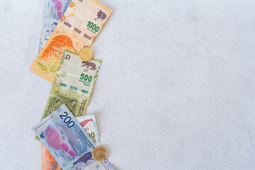 White background with argentine money on the left side
