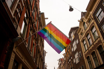 a rainbow flag waving on an old building in Brussels