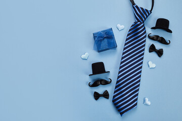 Father's Day poster or banner with necktie and decorations on blue background. Greetings for Father's Day. Flat lay styling. - obrazy, fototapety, plakaty