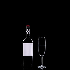 Wine bottle with blank label and glass on black isolated background