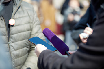 News broadcasting and recording protest on the streets.