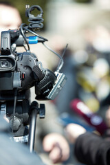 News broadcasting and recording protest on the streets.