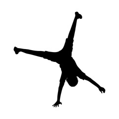 Silhouette boy standing on his one hand handstand.