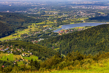Fototapeta na wymiar Panoramic view of Beskidy Mountains surrounding Miedzybrodzkie Lake and Porabka town seen from Gora Zar mountain near Zywiec in Silesia region of Poland